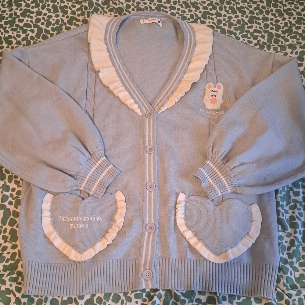 Light blue button up cardigan with heart shaped pockets